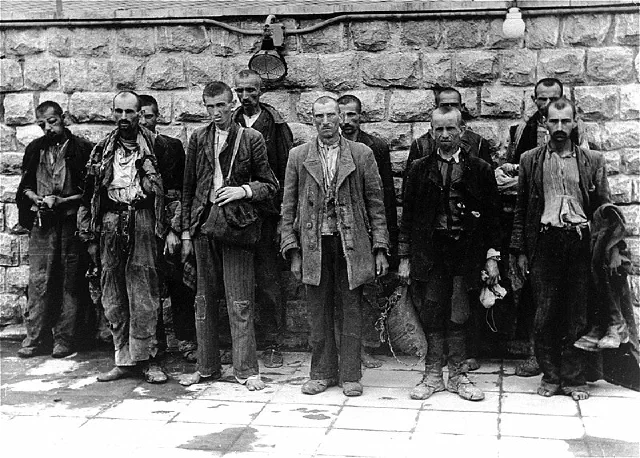 New prisoners who survived a weeklong trip in open boxcars awaiting disinfection at Mauthausen